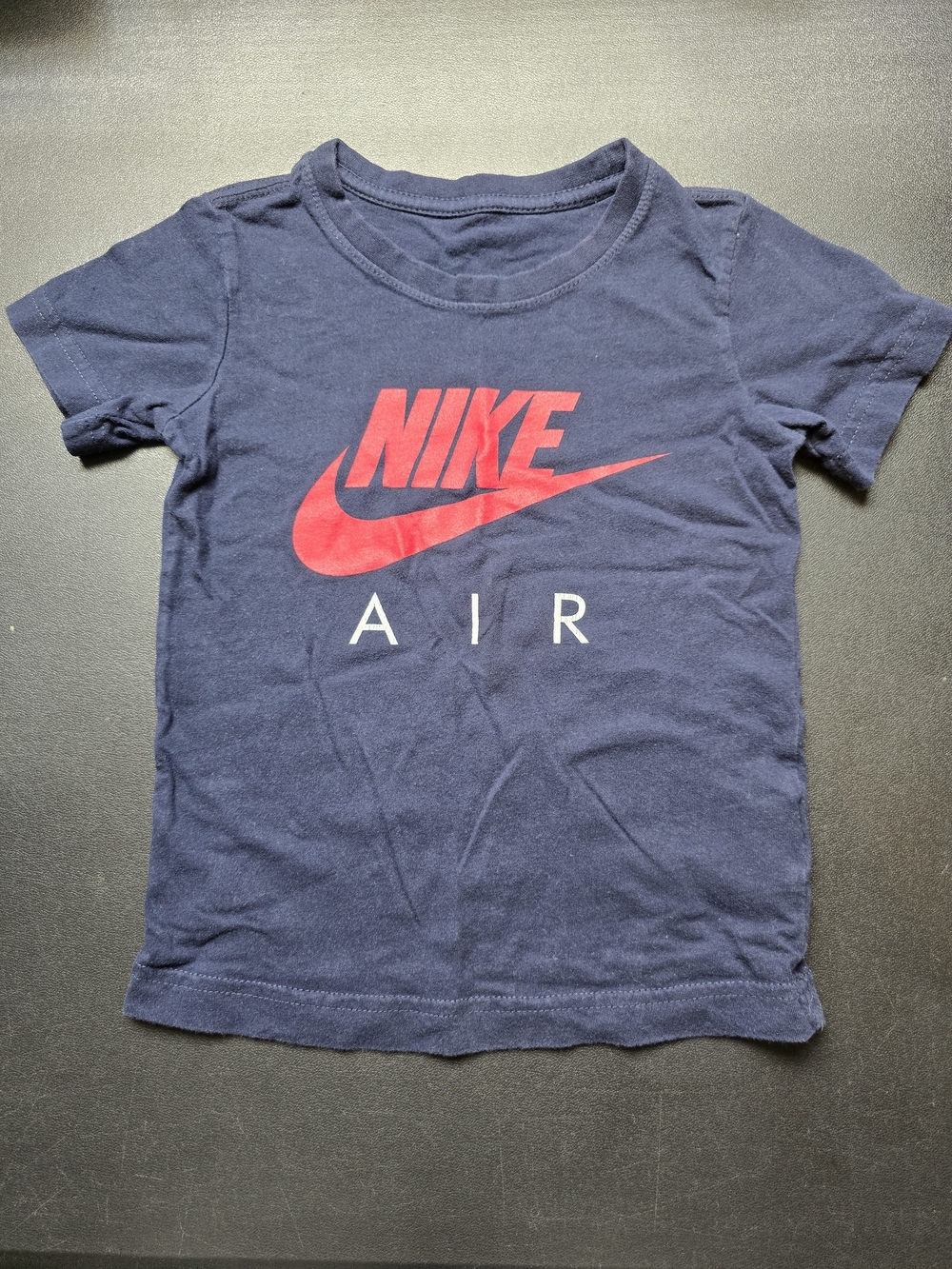 Nike Kids Navy Blue Tee with Red Nike Logo.